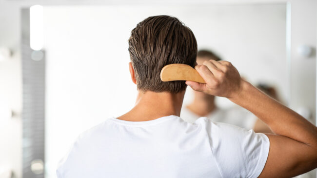Hair,Care.,Close,Up,Rear,View,Of,Young,Man,Hairbrushing